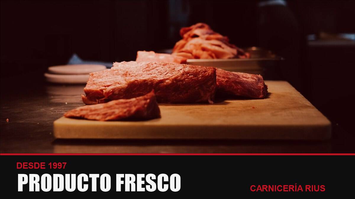 Carne fresca sobre una tabla de madera en una carnicería de Barcelona
